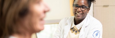 Asia McCoy speaking with a patient